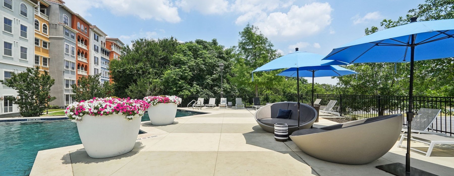 a terrace area next to a pool