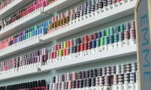 a shelf of nail polish and product
