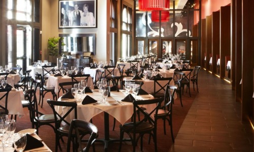 a room with many tables and red walls