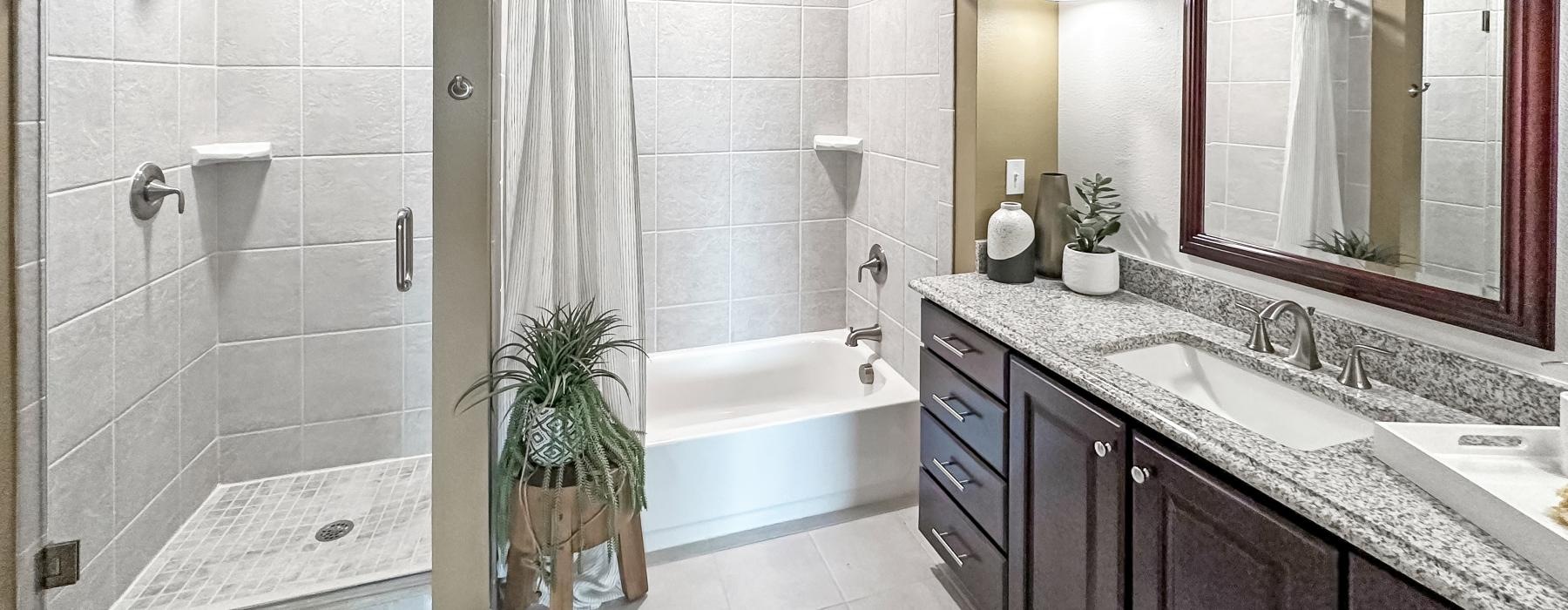 a bathroom with a tub sink and a shower